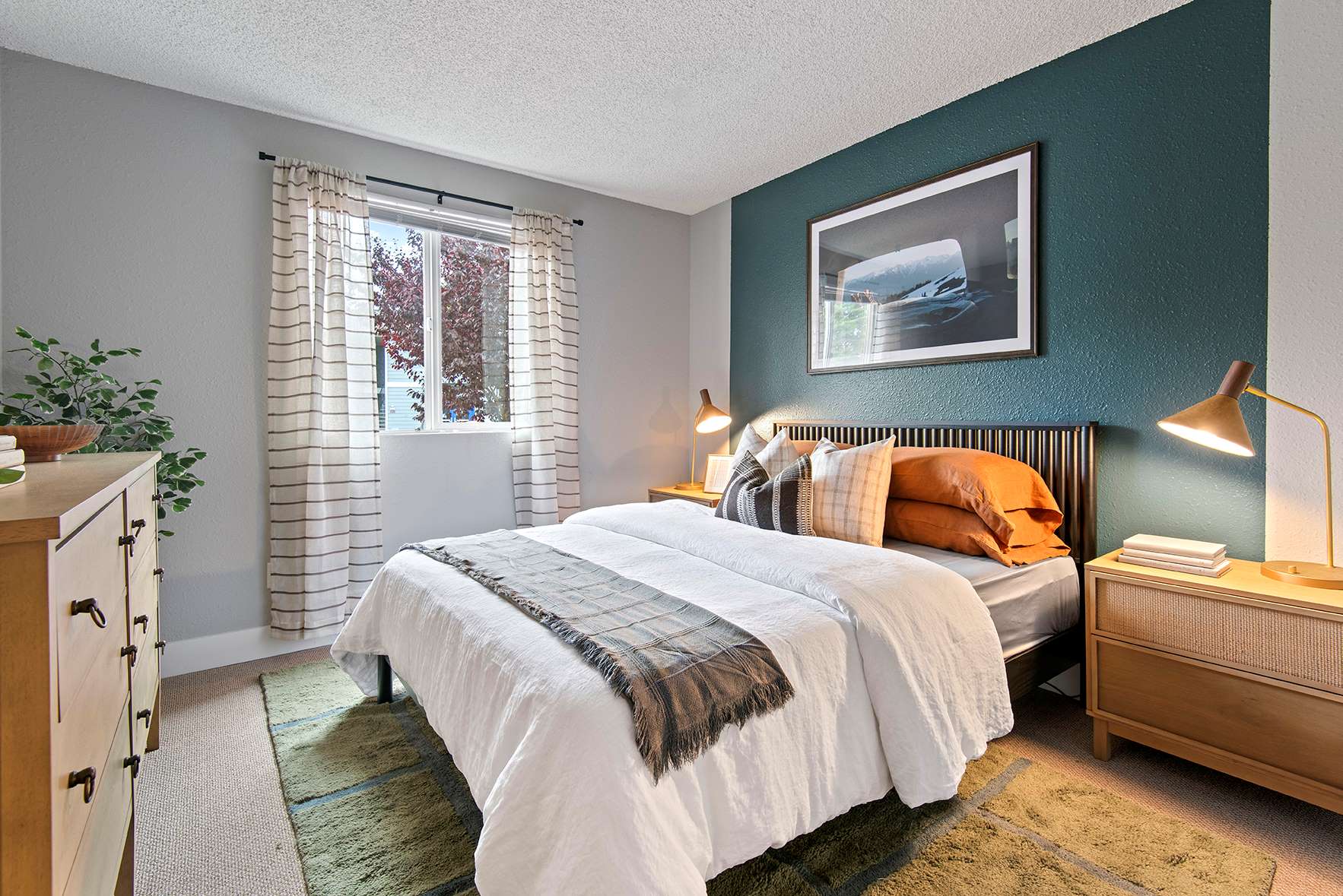 Comfortable bedroom with window at Irwin Park apartments in Kent